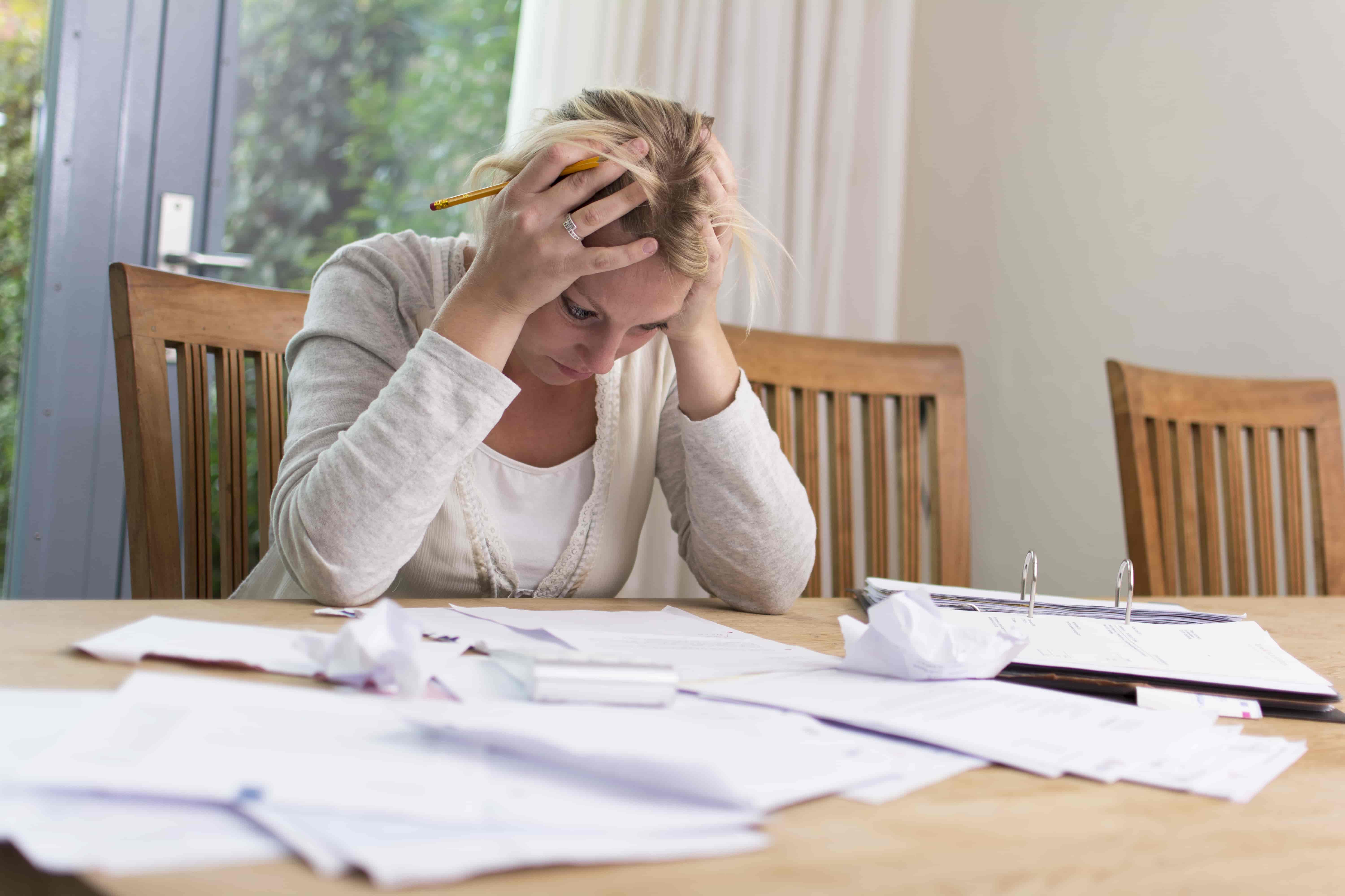 person stressed and struggling to file their own taxes